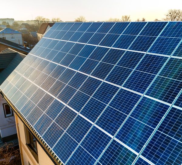 aerial-view-new-modern-two-story-house-cottage-with-blue-shiny-solar-photo-voltaic-panels-system-roof-renewable-ecological-green-energy-production-concept aerial-view-new-modern-two-story-house-cottage-with-blue-shiny-solar-photo-voltaic-panels-system-roof-renewable-ecological-green-energy-production-concept